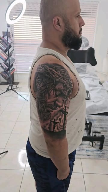 Christ and cross sleeve tattoo by Carlos Tattoo in Tallahassee
